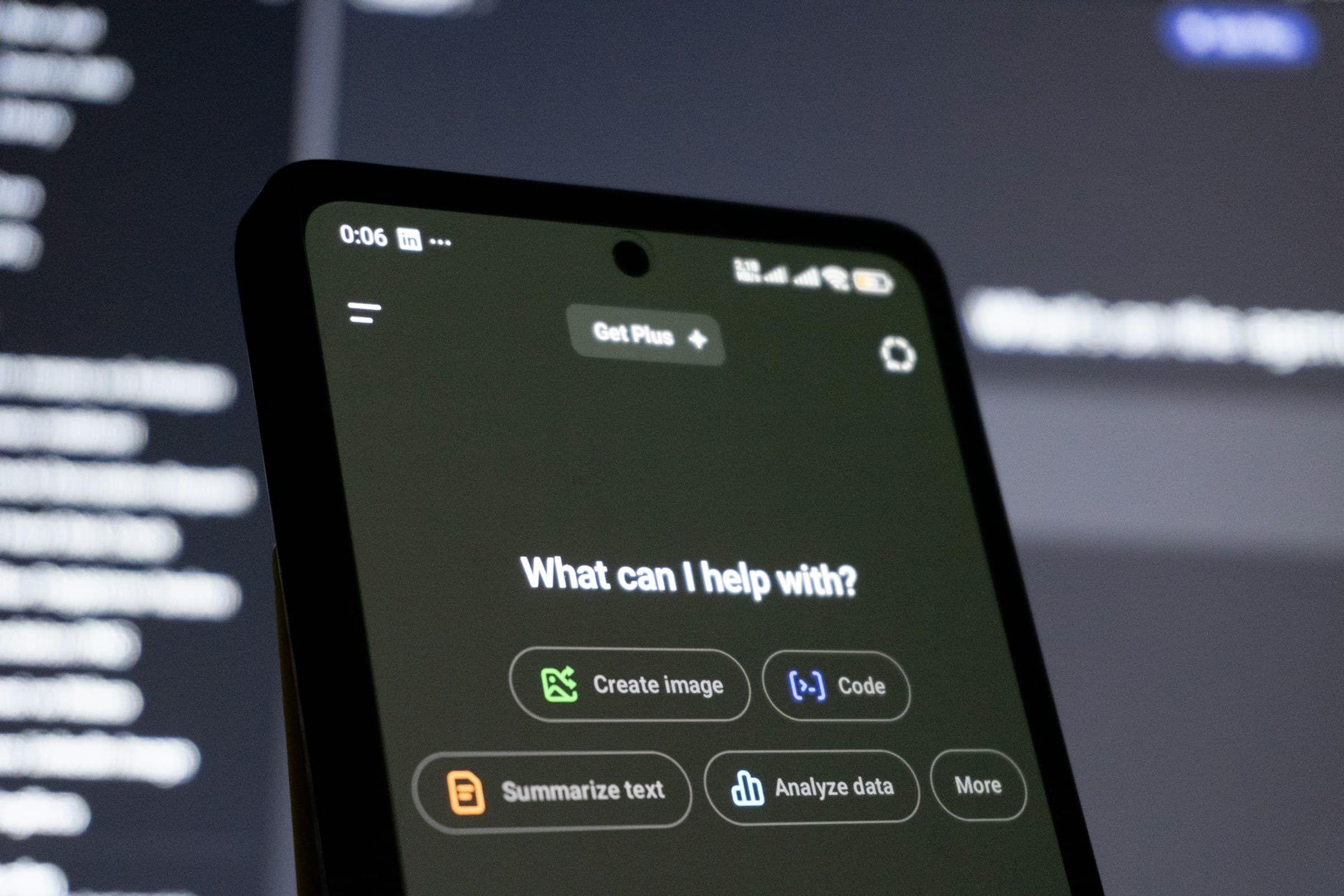 A phone screen showing an AI assistant, with options to create an image, write code, summarise text or analyse data.